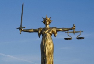 Statue of Justice. This bronze statue of Justice stands on top of the Central Criminal Court