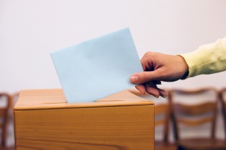 women in election with ballots and ballot box