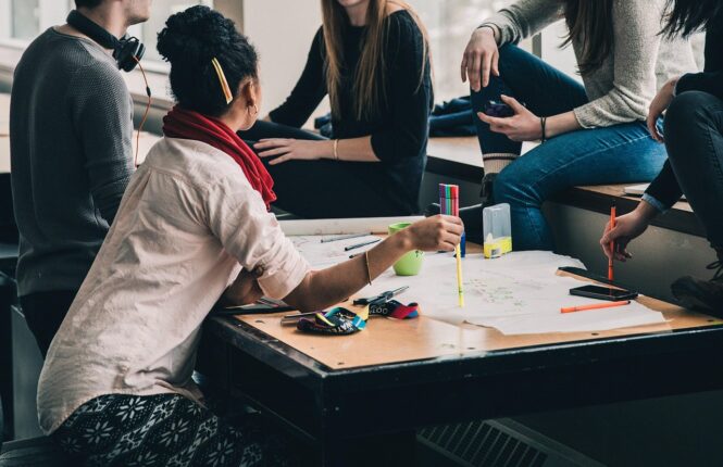Estudiantes comparten ideas en torno a una mesa