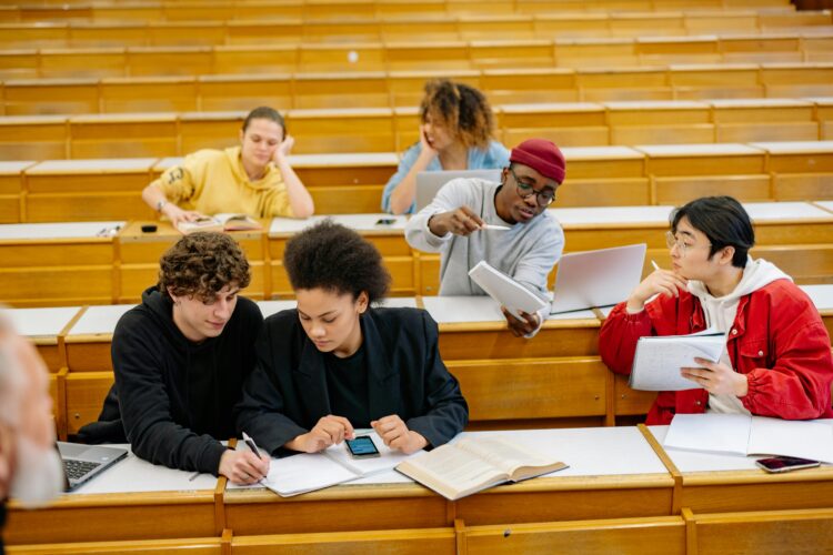 Estudiantes universitarios trabajan por parejas en un aula